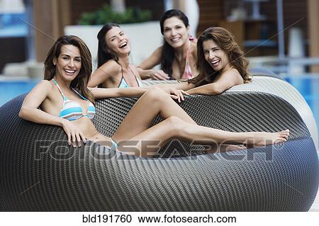 Smiling Hispanic women in poolside chairs View Large Photo Image Stock Image - Smiling Hispanic women in poolside chairs. Fotosearch