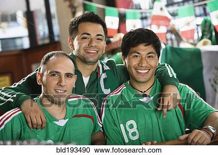 Stock Image - Smiling men in team uniforms. Fotosearch