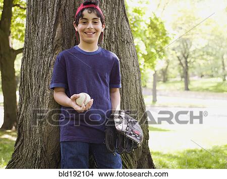 Smiling mixed race boy holding baseball and glove View Large Photo Image Picture - Smiling mixed race boy holding baseball and glove. Fotosearch