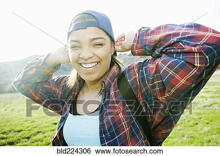 Smiling Mixed Race woman backpacking in field View Large Photo Image Stock Photograph - Smiling Mixed Race woman backpacking in field. Fotosearch