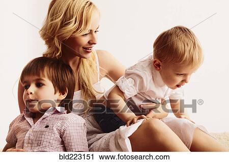 Smiling mother holding sons View Large Photo Image Stock Image - Smiling mother holding sons. Fotosearch