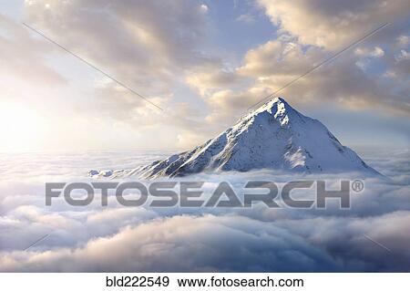 Snow-covered mountaintop above clouds View Large Photo Image Stock Photo - Snow-covered mountaintop above clouds. Fotosearch