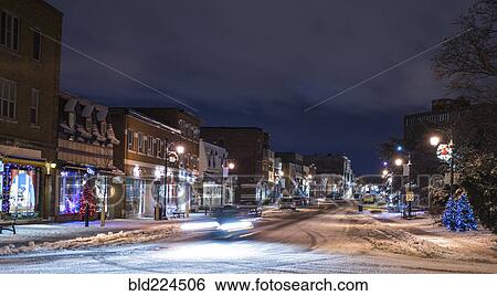 Stock Photograph - Snow on city street at night. Fotosearch