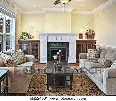 Sofa and loveseat near fireplace in livingroom View Large Photo Image Stock Image - Sofa and loveseat near fireplace in livingroom. Fotosearch
