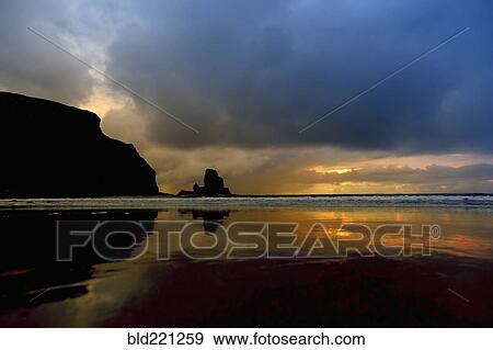 Stock Photo - Storm clouds over waves on beach. Fotosearch
