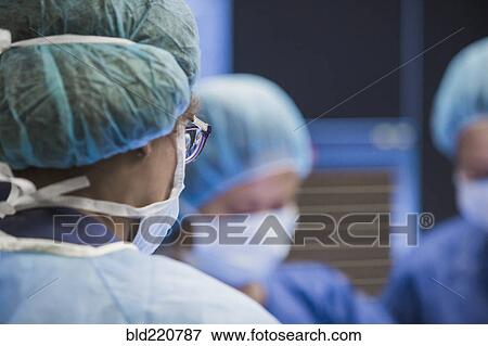 Stock Photo - Surgeons working in operating room. Fotosearch