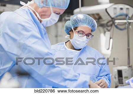 Surgeons working in operating room View Large Photo Image Stock Photograph - Surgeons working in operating room. Fotosearch