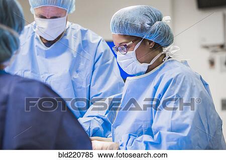 Surgeons working in operating room View Large Photo Image Stock Photography - Surgeons working in operating room. Fotosearch