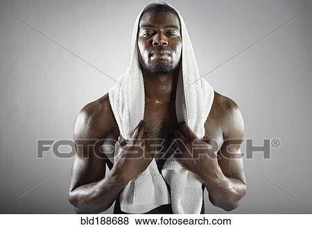 Stock Photo - Sweating African man with towel. Fotosearch