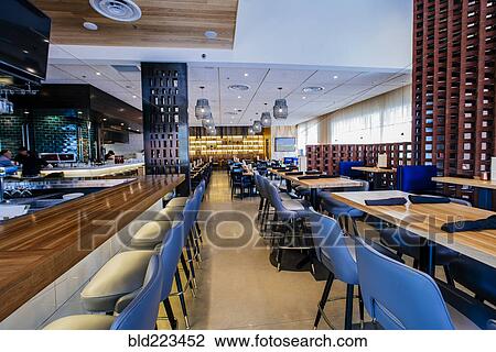 Stock Image - Tables and chairs in modern bar and restaurant. Fotosearch