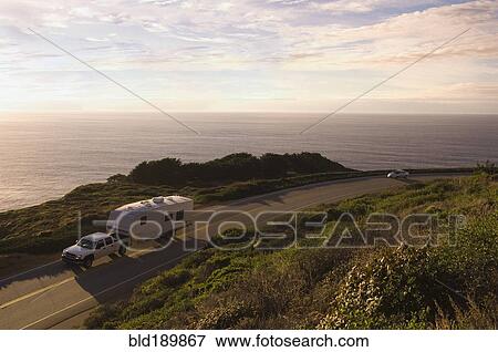 Truck pulling camper on coastal highway View Large Photo Image Stock Photo - Truck pulling camper on coastal highway. Fotosearch