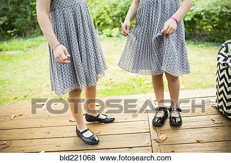 Twin sisters standing on deck View Large Photo Image Stock Photo - Twin sisters standing on deck. Fotosearch