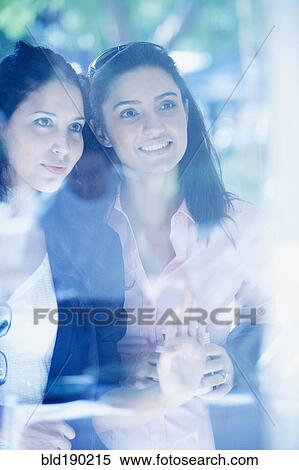 Stock Photography - Two Hispanic woman window shopping. Fotosearch