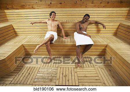 Stock Photograph - Two multi-ethnic men relaxing in sauna. Fotosearch