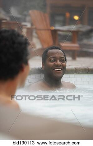 Two multi-ethnic men sitting in hot tub View Large Photo Image Stock Image - Two multi-ethnic men sitting in hot tub. Fotosearch