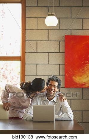 Woman kissing husband's cheek View Large Photo Image Stock Photo - Woman kissing husband's cheek. Fotosearch