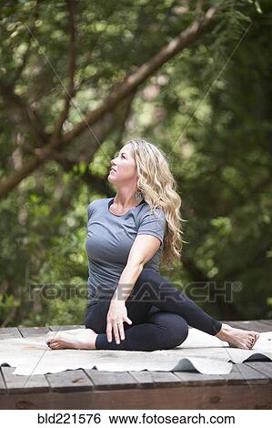 Woman practicing yoga outdoors View Large Photo Image Stock Photograph - Woman practicing yoga outdoors. Fotosearch