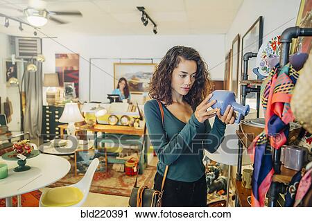 Stock Image - Woman shopping in store. Fotosearch