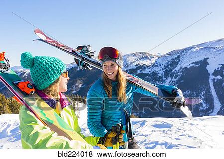 Women carrying skis on snowy mountain View Large Photo Image Stock Photo - Women carrying skis on snowy mountain. Fotosearch