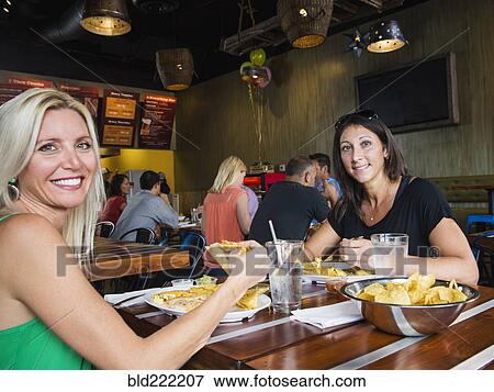 Women eating in cafe View Large Photo Image Stock Photo - Women eating in cafe. Fotosearch
