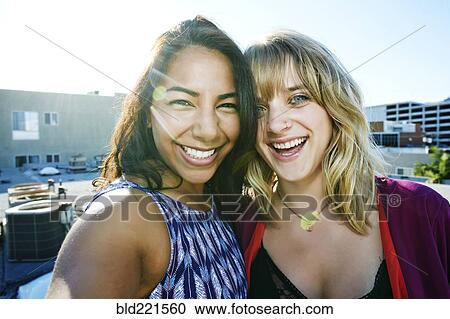 Women hugging on urban rooftop View Large Photo Image Stock Image - Women hugging on urban rooftop. Fotosearch