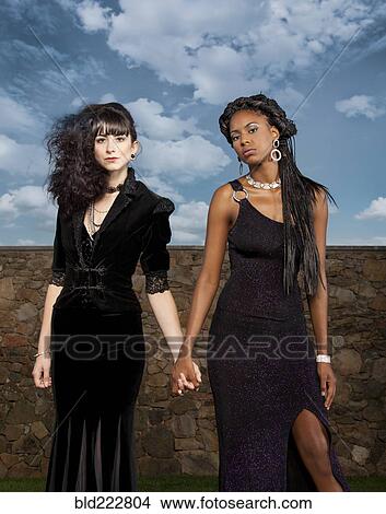 Women in black dresses holding hands View Large Photo Image Picture - Women in black dresses holding hands. Fotosearch