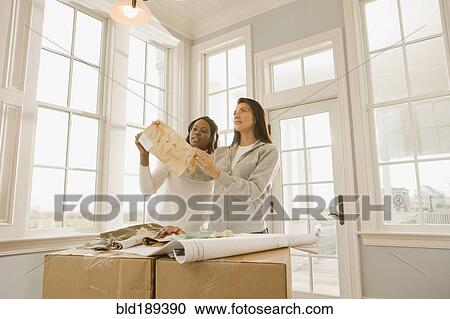 Stock Image - Women planning interior design. Fotosearch
