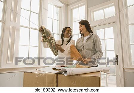 Stock Image - Women planning interior design. Fotosearch