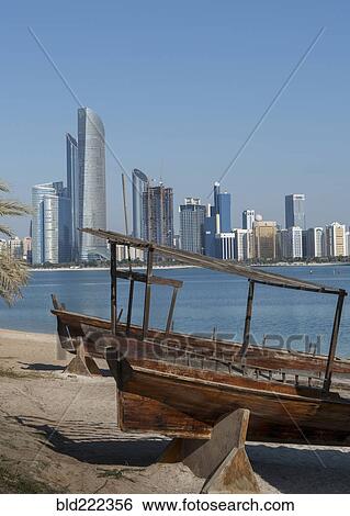 Stock Photograph - "Wooden boats at urban waterfront, Abu Dhabi, Abu Dhabi Emirate, United Arab Emirates, ". Fotosearch