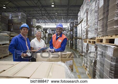 Workers smiling in warehouse View Large Photo Image Stock Photo - Workers smiling in warehouse. Fotosearch