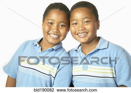 Stock Image - Young African twin brothers hugging and smiling. Fotosearch