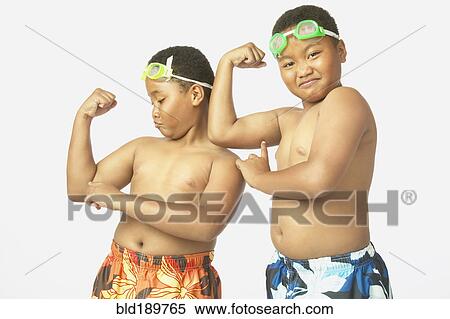 Young African twin brothers in bathing suits flexing View Large Photo Image Stock Photography - Young African twin brothers in bathing suits flexing. Fotosearch
