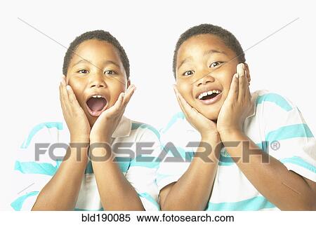 Stock Photography - Young African twin brothers looking surprised. Fotosearch