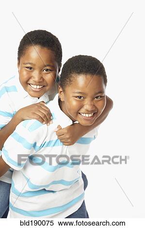 Stock Photography - Young African twin brothers smiling. Fotosearch