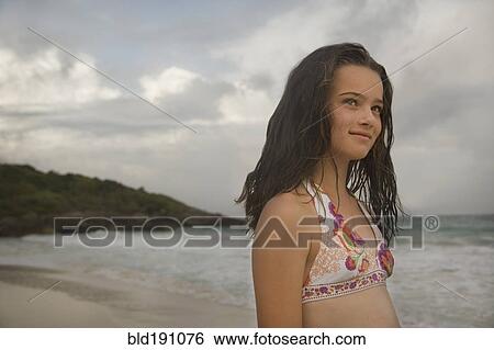 Young girl in bikini at beach View Large Photo Image Stock Photograph - Young girl in bikini at beach. Fotosearch
