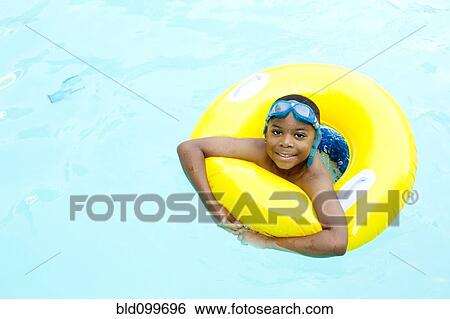 African American boy playing in swimming pool View Large Photo Image Stock Photograph - African American boy playing in swimming pool. Fotosearch
