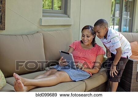 Stock Photo - African American mother and son using digital tablet. Fotosearch