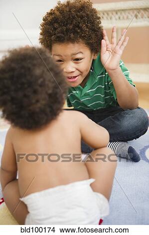 Picture - Black brother and sister playing. Fotosearch
