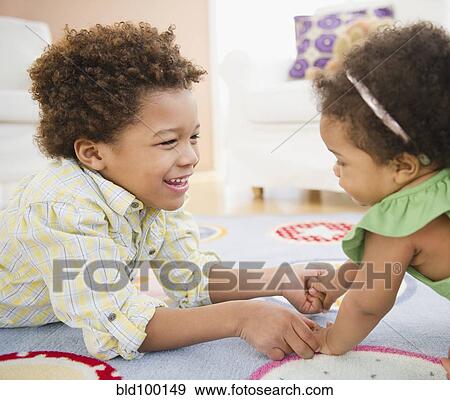 Black brother and sister playing together View Large Photo Image Stock Photo - Black brother and sister playing together. Fotosearch