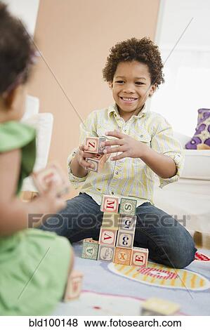 Black brother and sister playing with blocks View Large Photo Image Stock Photo - Black brother and sister playing with blocks. Fotosearch