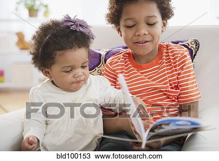 Black brother reading book to sister View Large Photo Image Stock Image - Black brother reading book to sister. Fotosearch