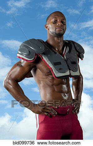 Black football player in shoulder pads View Large Photo Image Stock Photograph - Black football player in shoulder pads. Fotosearch