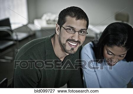 Stock Photo - Business people working together in office. Fotosearch