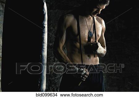 Caucasian boxer standing near punching bag View Large Photo Image Picture - Caucasian boxer standing near punching bag. Fotosearch