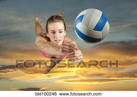 Caucasian volleyball player hitting volleyball View Large Photo Image Stock Photograph - Caucasian volleyball player hitting volleyball. Fotosearch