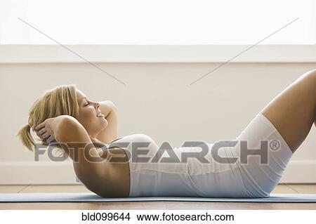 Picture - Caucasian woman doing sit-ups. Fotosearch