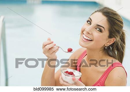 Caucasian woman eating yogurt and berries View Large Photo Image Stock Photography - Caucasian woman eating yogurt and berries. Fotosearch