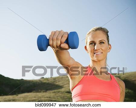 Stock Photo - Caucasian woman exercising outdoors. Fotosearch
