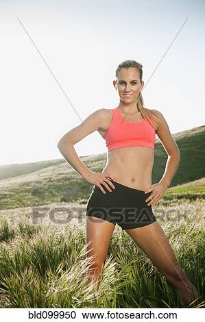 Caucasian woman in sportswear standing outdoors View Large Photo Image Stock Image - Caucasian woman in sportswear standing outdoors. Fotosearch