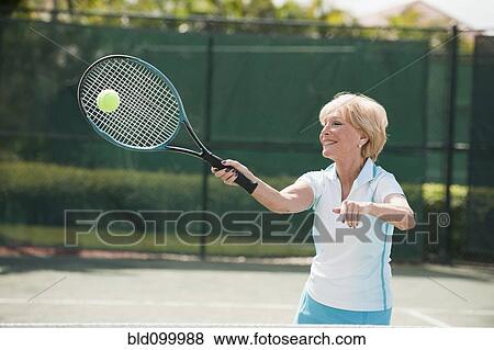 Caucasian woman playing tennis View Large Photo Image Stock Photo - Caucasian woman playing tennis. Fotosearch
